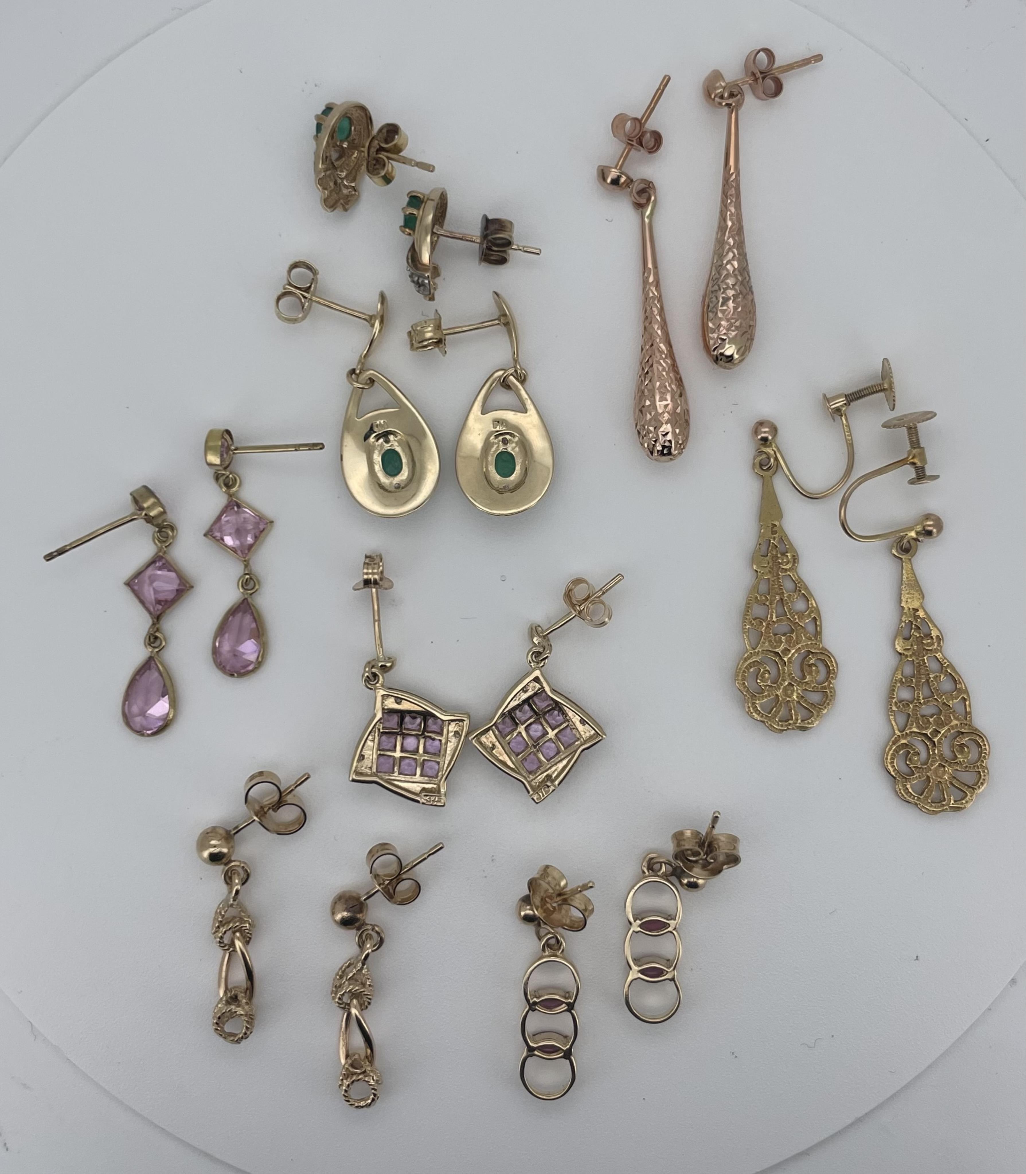 A modern pair of 14k yellow metal, emerald, diamond and enamel set oval drop earrings, 23mm, a similar pair of 10k yellow metal and gem set earrings and six other assorted modern pairs of 9ct/375 earrings including three